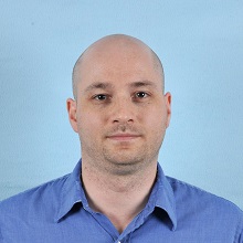 Official State Department example of an unacceptable passport photo with a blue background